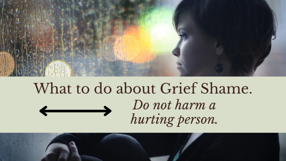 What to do about grief shame: do not harm a hurting person. Woman sits in front of a rainy window.