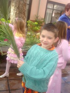 Seven-Year-Old Samuel preparing for Palm Sunday Service in 2008. Little Children at this church provide hope for the participants in the beginning of the Christian Celebration of Holy Week. 