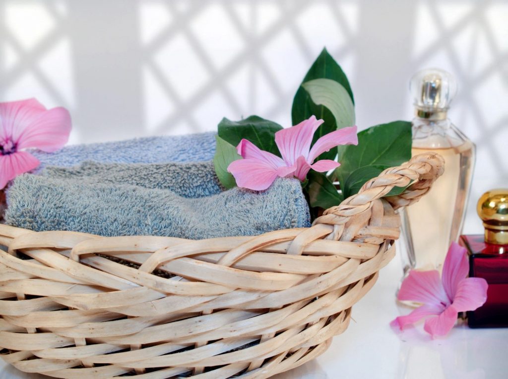 Basket of possibilities: a beige basket with towels and flowers, an image of self care