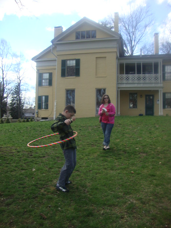 My son, Samuel, is hula hooping on Emily Dickinson's lawn. 