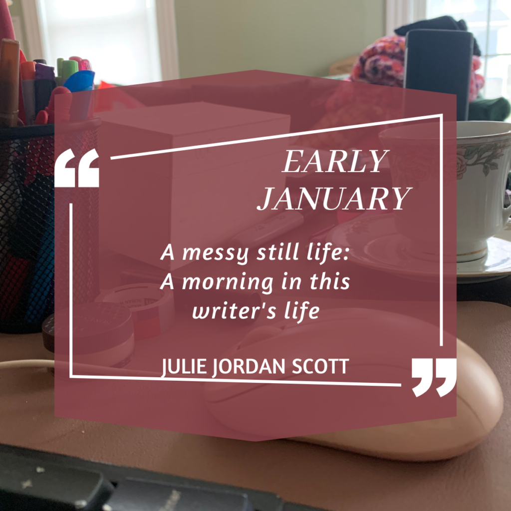 A messy writer's desk in early January. A tea cup, pens, collections of nothingness.